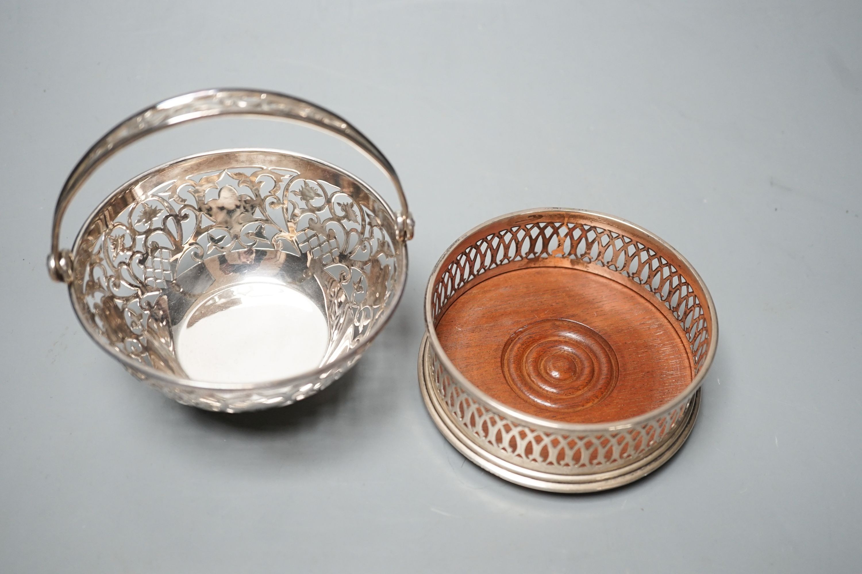 A modern pierced silver sweetmeat basket, 10cm and a similar pierced silver wine coaster.